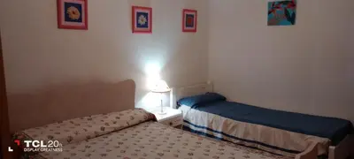 a bedroom with two beds and a lamp on a table at Hospedaje LA LUCIA in Almafuerte