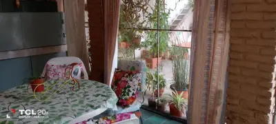 a balcony with a table and chairs in front of a window at Hospedaje LA LUCIA in Almafuerte