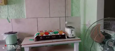 a cake sitting on a table next to a fan at Hospedaje LA LUCIA in Almafuerte
