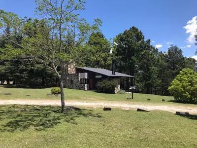 a house in the middle of a field with a tree at Niderost in Villa Berna