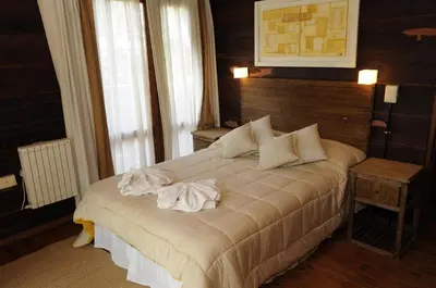 a bedroom with a bed with towels on it at Niderost in Villa Berna