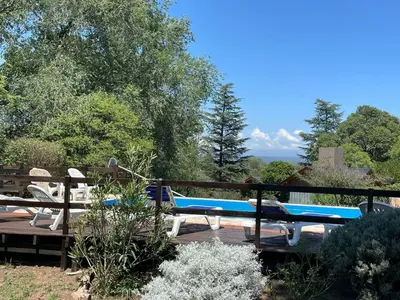 a couple of blue benches sitting on a deck at Loma Dorada Cabañas in Villa General Belgrano