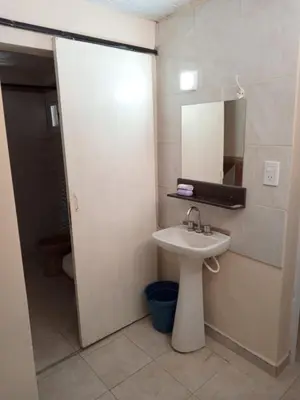 a bathroom with a sink and a mirror at Depto Santo Brochero centro in Villa Cura Brochero