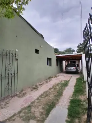 a car parked in a garage next to a building at Depto Santo Brochero centro in Villa Cura Brochero
