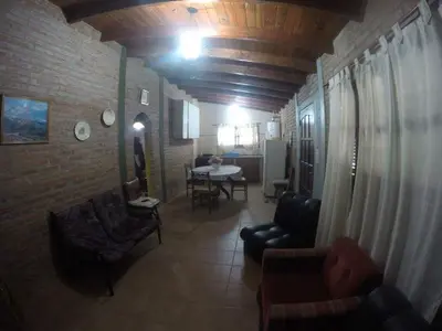 a living room with chairs and a table in a room at Granate in Villa Cura Brochero