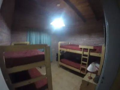 a small room with two bunk beds and a light at Granate in Villa Cura Brochero