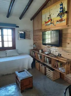 a bedroom with a bed and a flat screen tv at VILLA ESPINA CHALET DE MONTAÑA a 8 km de San Javier in Villa de Las Rosas