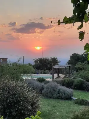 a sunset over a garden with a gazebo at VILLA ESPINA CHALET DE MONTAÑA a 8 km de San Javier in Villa de Las Rosas
