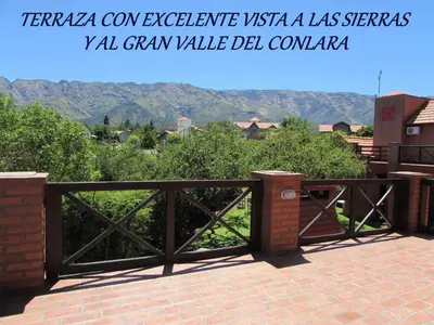 a wooden gate with a view of a mountain at Cabañas El Maiten in Merlo