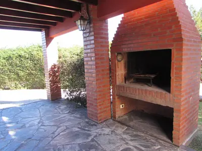 an outdoor brick oven with a table in it at Cabañas El Maiten in Merlo