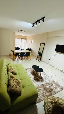a living room with a green couch and a table at Bv San Juan - Nva Cba in Cordoba