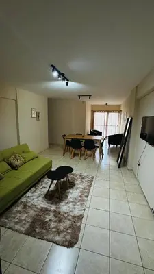 a living room with a green couch and a table at Bv San Juan - Nva Cba in Cordoba