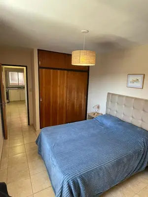 a bedroom with a bed with a blue blanket at Bv San Juan - Nva Cba in Cordoba