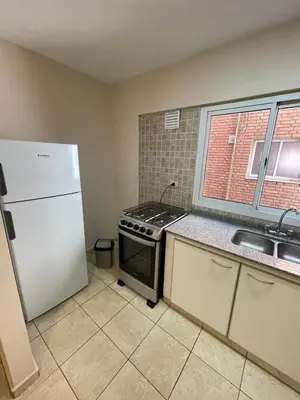 a kitchen with a stove and a white refrigerator at Bv San Juan - Nva Cba in Cordoba