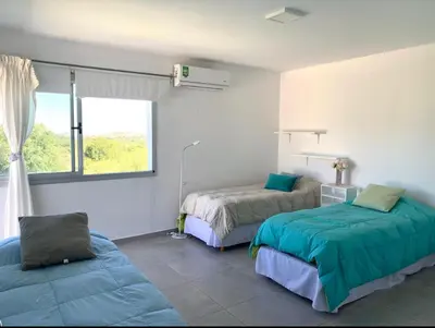 a bedroom with two beds and a window at Tierra Alta, Comarca Serrana in Cordoba