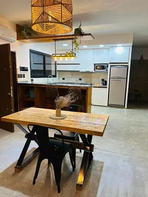 a large kitchen with a wooden table in a room at Casa Simona in Las Rabonas