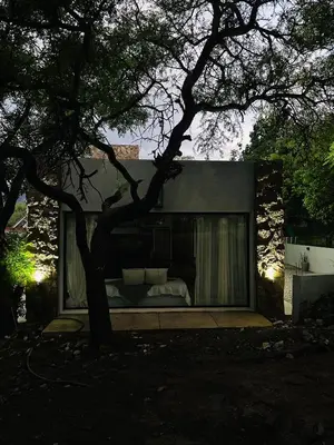 a house with a bed and a tree at Casa Simona in Las Rabonas