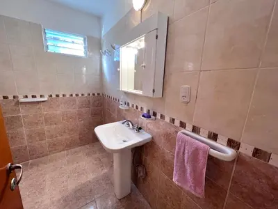 a bathroom with a sink and a mirror at Hermosa y amplia casa con pileta in San Antonio de Arredondo