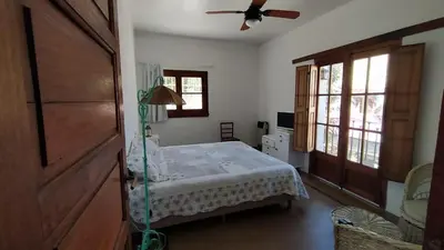 a bedroom with a bed and a ceiling fan at El depto de Bowie in Santa Rosa de Calamuchita