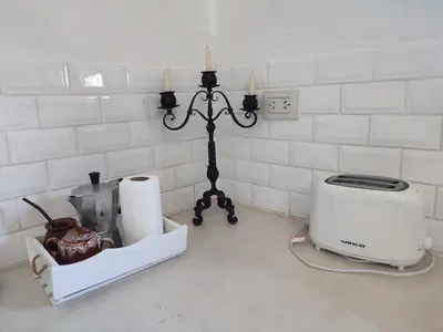 a counter with a toaster and a toaster and candles at El depto de Bowie in Santa Rosa de Calamuchita
