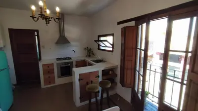 a kitchen with a sink and a stove at El depto de Bowie in Santa Rosa de Calamuchita