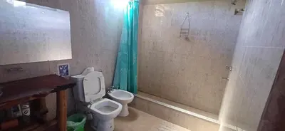 a bathroom with a toilet and a shower at La Casa de Piedra in Villa Santa Cruz del Lago