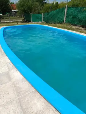 a blue fiberglass swimming pool at La Casa de Piedra in Villa Santa Cruz del Lago