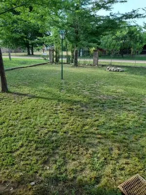 a light pole in a park with trees and grass at rafaella in Villa Anizacate