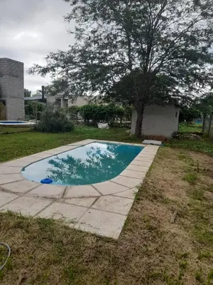 a small swimming pool in a yard with a tree at rafaella in Villa Anizacate