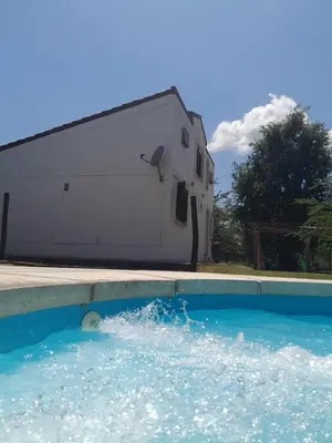a pool of water in front of a building at rafaella in Villa Anizacate