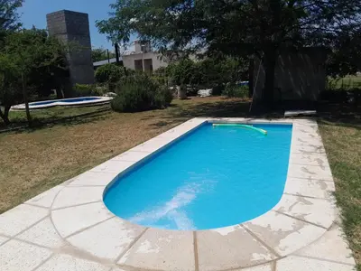 a large blue swimming pool in a yard at rafaella in Villa Anizacate