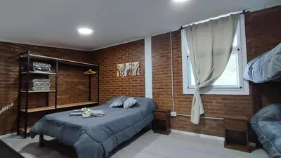 a bedroom with a bed and a window at Cabañas Estancia del Pilar - Cabañas de montaña in Estancia Vieja