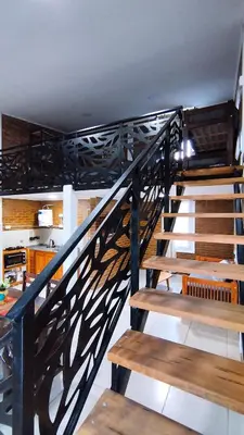 a wooden staircase with wooden benches in a room at Cabañas Estancia del Pilar - Cabañas de montaña in Estancia Vieja