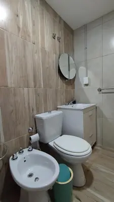 a bathroom with a toilet and a sink at Cabañas Estancia del Pilar - Cabañas de montaña in Estancia Vieja