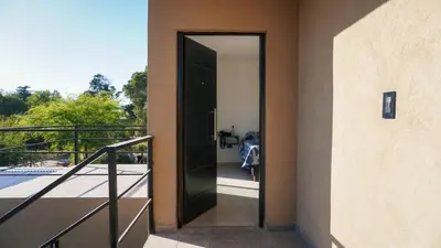a door is open to a balcony with a view at Complejo Giraluna in Almafuerte