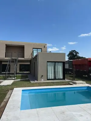 a house with a swimming pool in front of it at Complejo Giraluna in Almafuerte