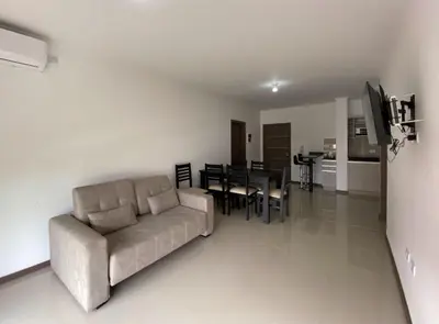 a living room with a couch and a dining room at Edificio Veneto IV - Departamento centrico frente al puente peatonal in Villa Carlos Paz