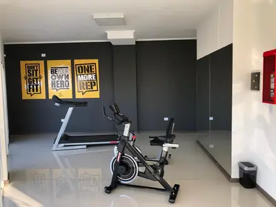 a room with a gym with a exercise bike at Edificio Veneto IV - Departamento centrico frente al puente peatonal in Villa Carlos Paz