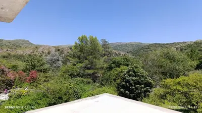 a view of the mountains from the roof of a house at Casa de adobe Cuesta blanca in Cordoba
