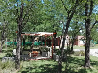 a pavilion in a park with trees at Alma Serrana Apart Cabañas - Solo Adultos in Nono