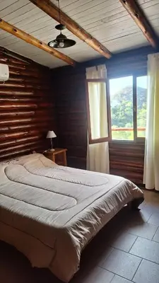 a large bed in a room with a window at Balcón de Los Aromos in La Bolsa