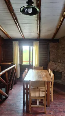 a dining room with a wooden table and chairs at Balcón de Los Aromos in La Bolsa