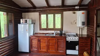 a kitchen with a white refrigerator and a stove at Balcón de Los Aromos in La Bolsa