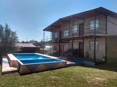 a house with a swimming pool in front of it at La Posada De Vito in Cordoba