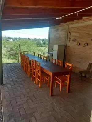 a long wooden table and chairs in a room at La Posada De Vito in Cordoba