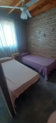 a bedroom with two beds and a ceiling fan at La Posada De Vito in Cordoba