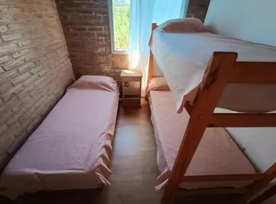 a small room with two bunk beds and a window at La Posada De Vito in Cordoba