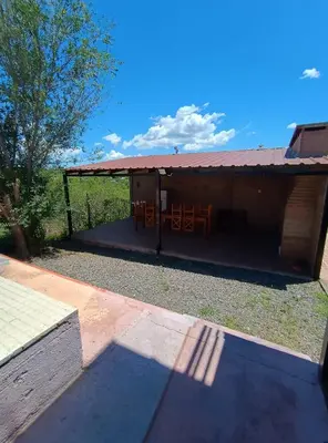 a pavilion with a table and chairs under it at La Posada De Vito in Cordoba