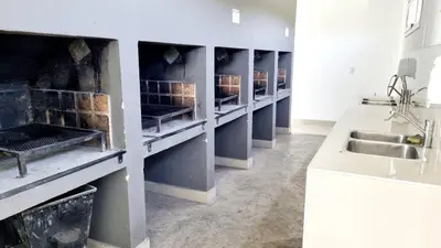 a kitchen with a row of sinks in a room at Departamento frente a lago Carlos Paz - Villa Siquiman - Complejo Veneto Village in Villa Parque Siquiman