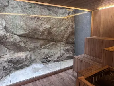 a bathroom with a large rock wall at Departamento frente a lago Carlos Paz - Villa Siquiman - Complejo Veneto Village in Villa Parque Siquiman